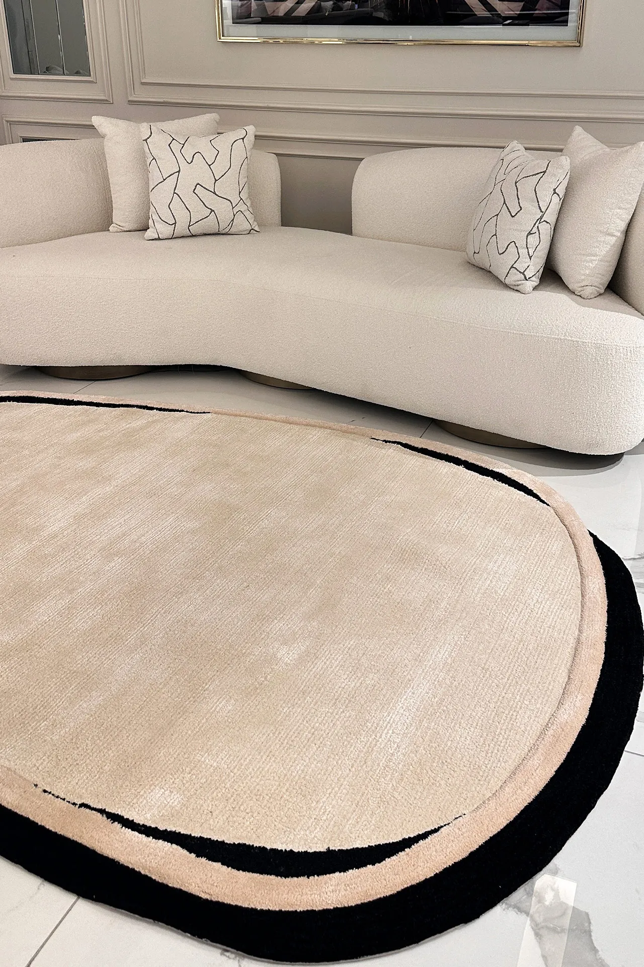 Oval beige and black rug  